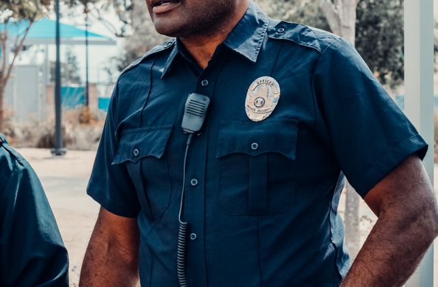 Professional armed security officer prepared for protective coverage